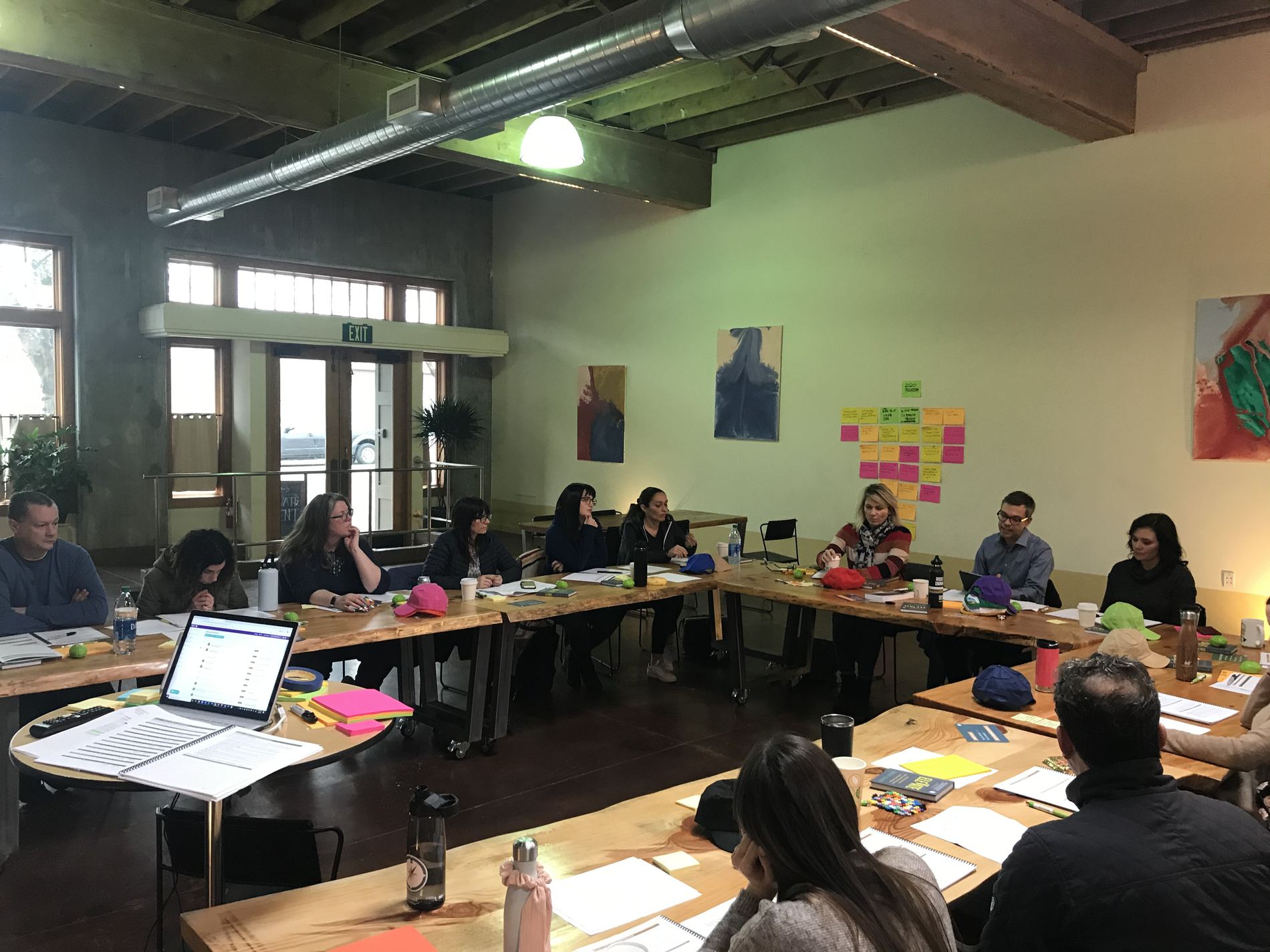 A Cadence Growth planning session in progress: a leadership team working a plan around a U-shaped table
